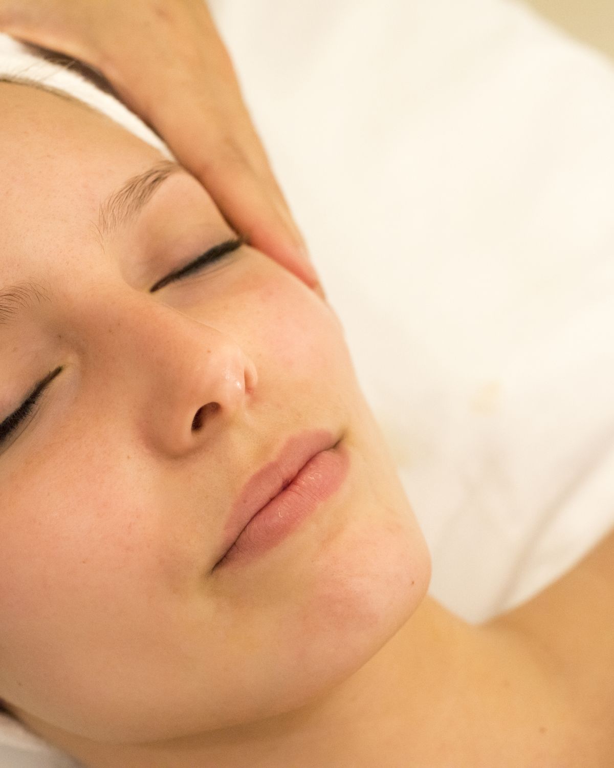 A guest relaxing during a facial