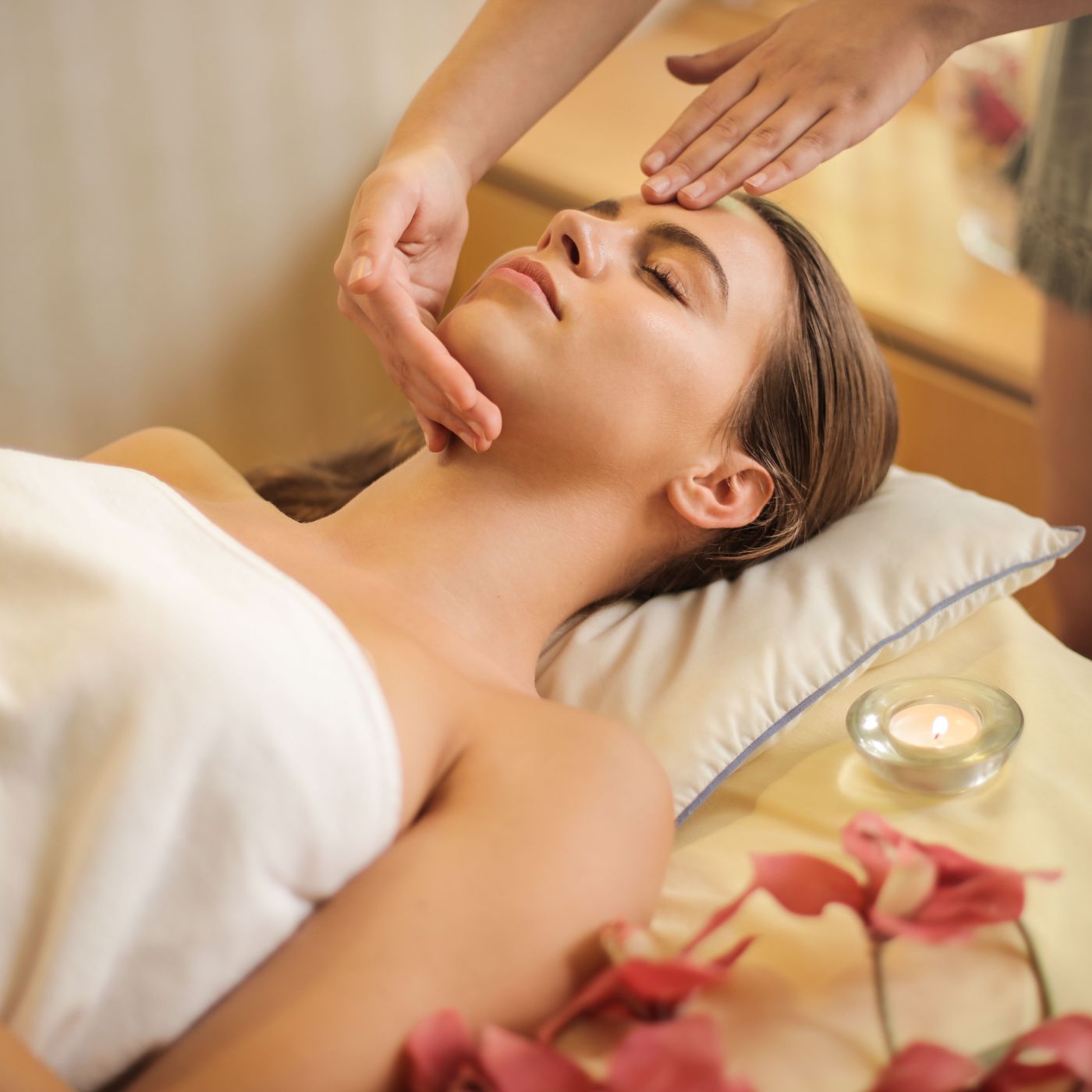 An esthetician applying a mask during a facial